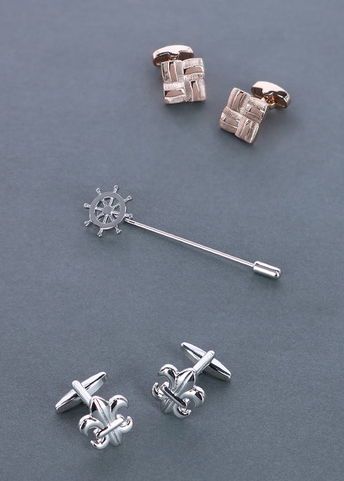 Two cufflinks and lapel pin