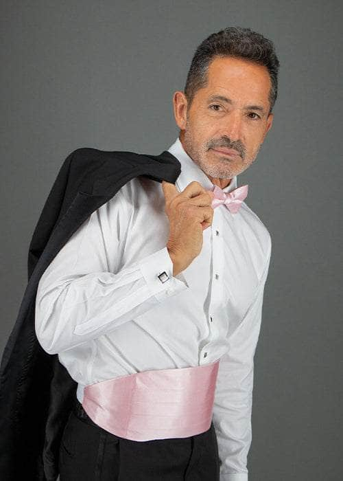 Man wearing a tuxedo with the pink sutton bow tie and cummerbund